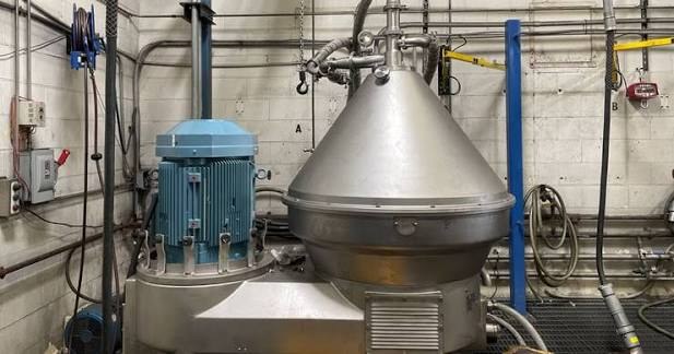 Representative image of an oil-water centrifugal separator with motor and separator bowl